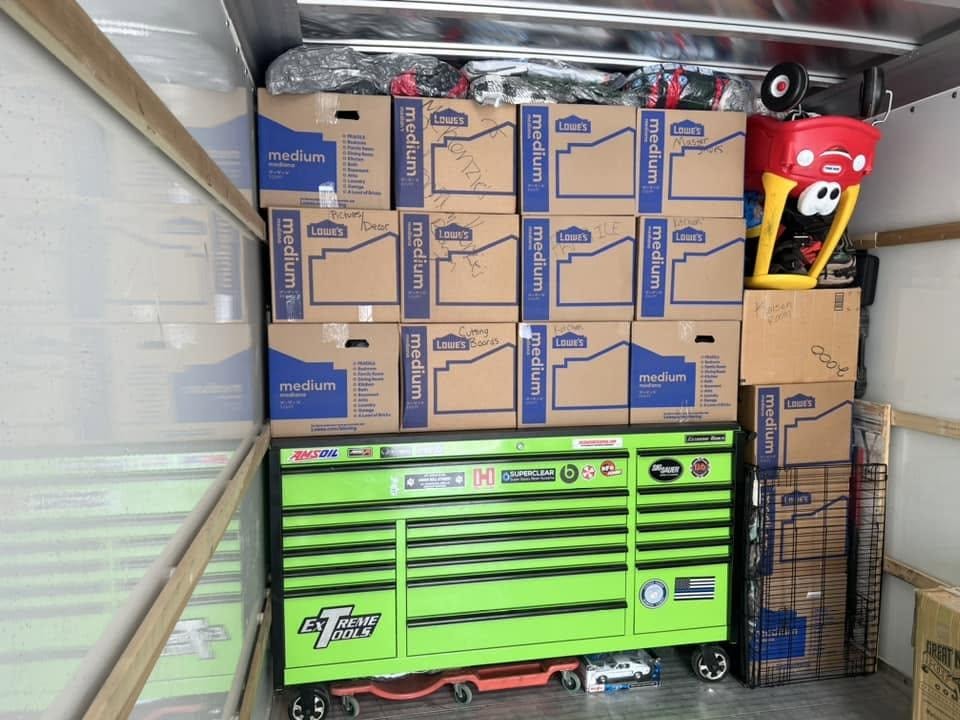 Professional movers carefully loading a truck